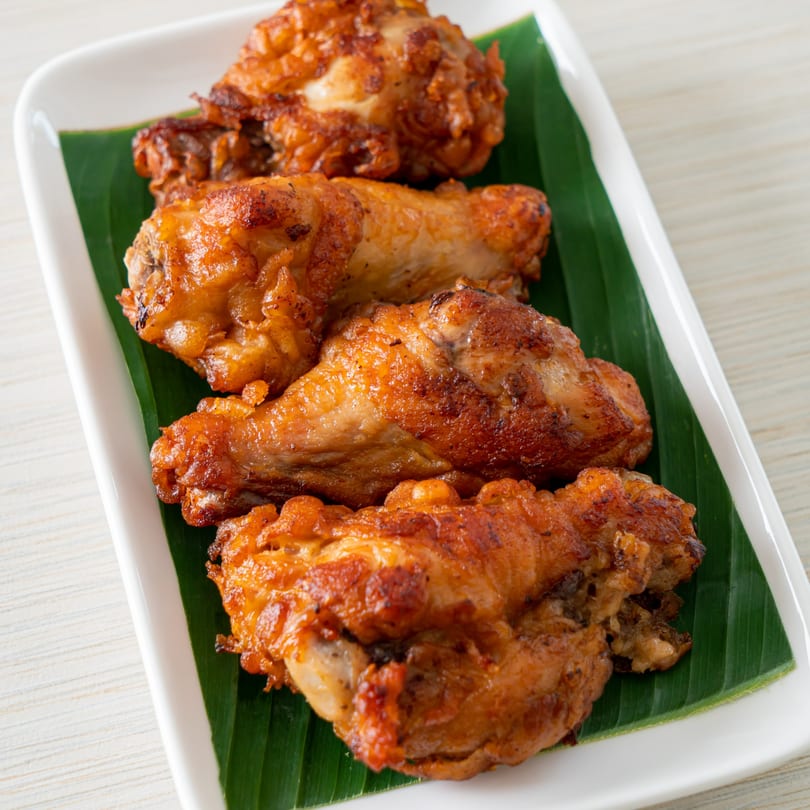 Four pieces of golden brown fried chicken, likely a side dish at Rick's Cheese Steak Shop.