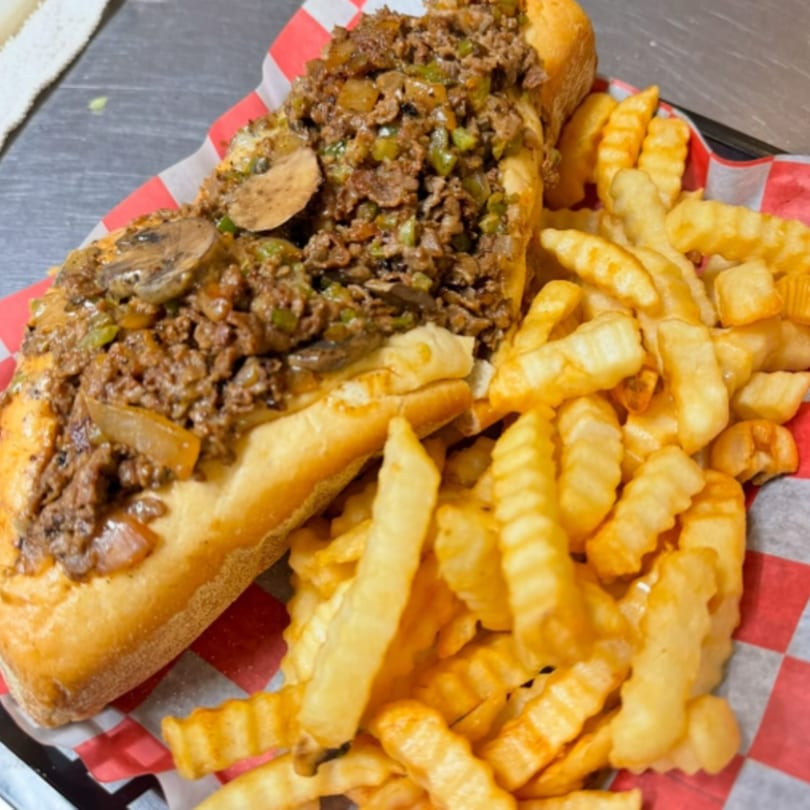 Rick's Cheese Steak Shop cheesesteak with mushrooms, onions, and peppers, served with crinkle-cut fries.